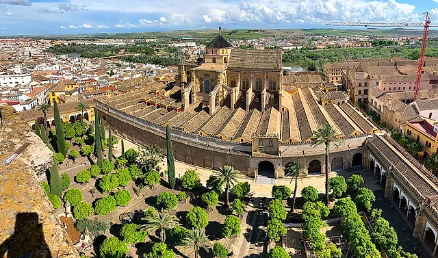 View from above of the Patio de los Naranjos, with its rows of orange trees, and the long tiled roofs of the Mosque-Cathedral of Córdoba